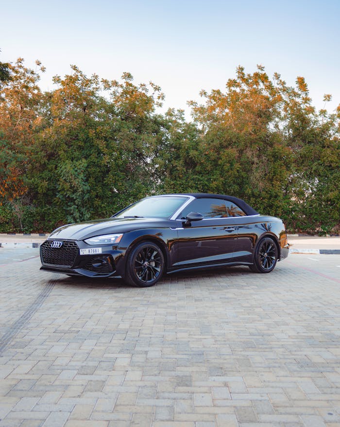pexels photo 27830039 Sleek black Audi convertible car parked outdoors in Dubai showcasing luxury design.